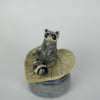 Leaf Laying Raccoon Trinket